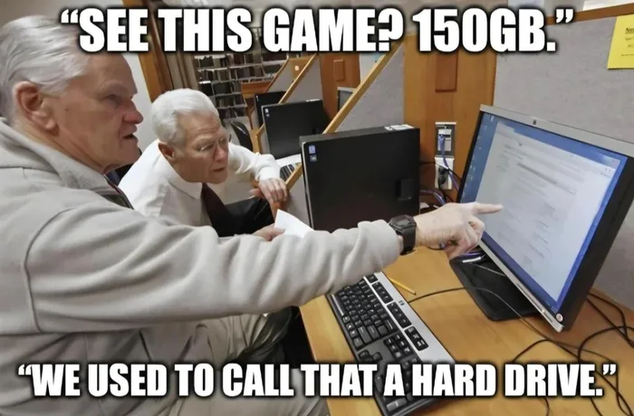 Two elderly men at a computer desk pointing at the screen, with meme captions about modern game install sizes versus old hard drive capacity.