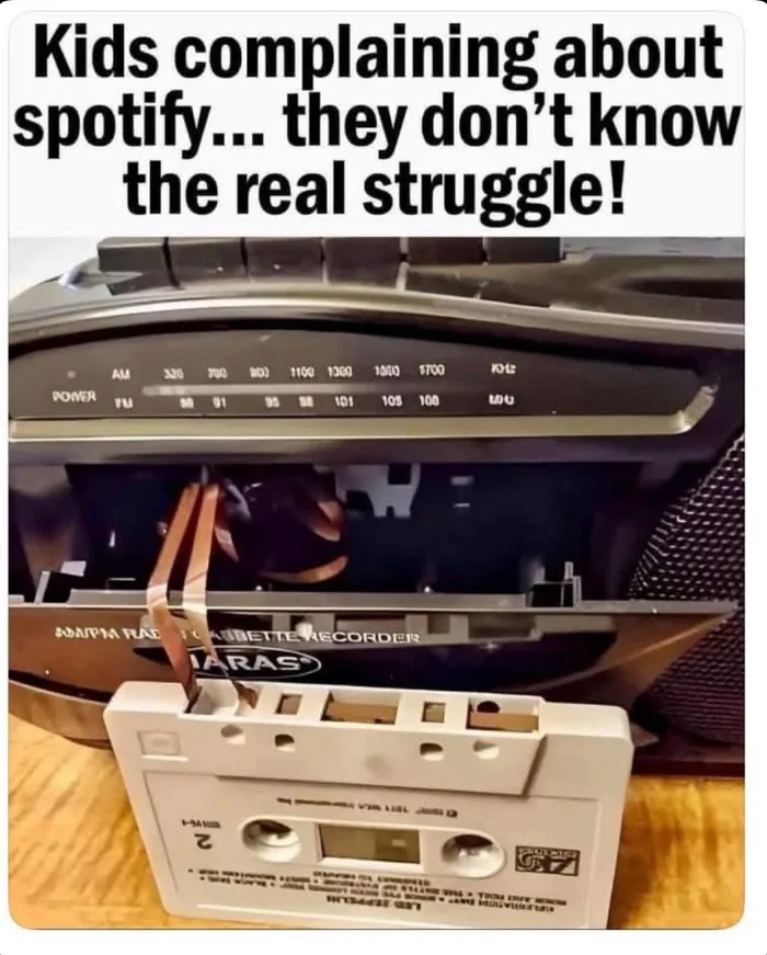 A cassette tape player with magnetic tape pulled out and tangled inside the deck mechanism.