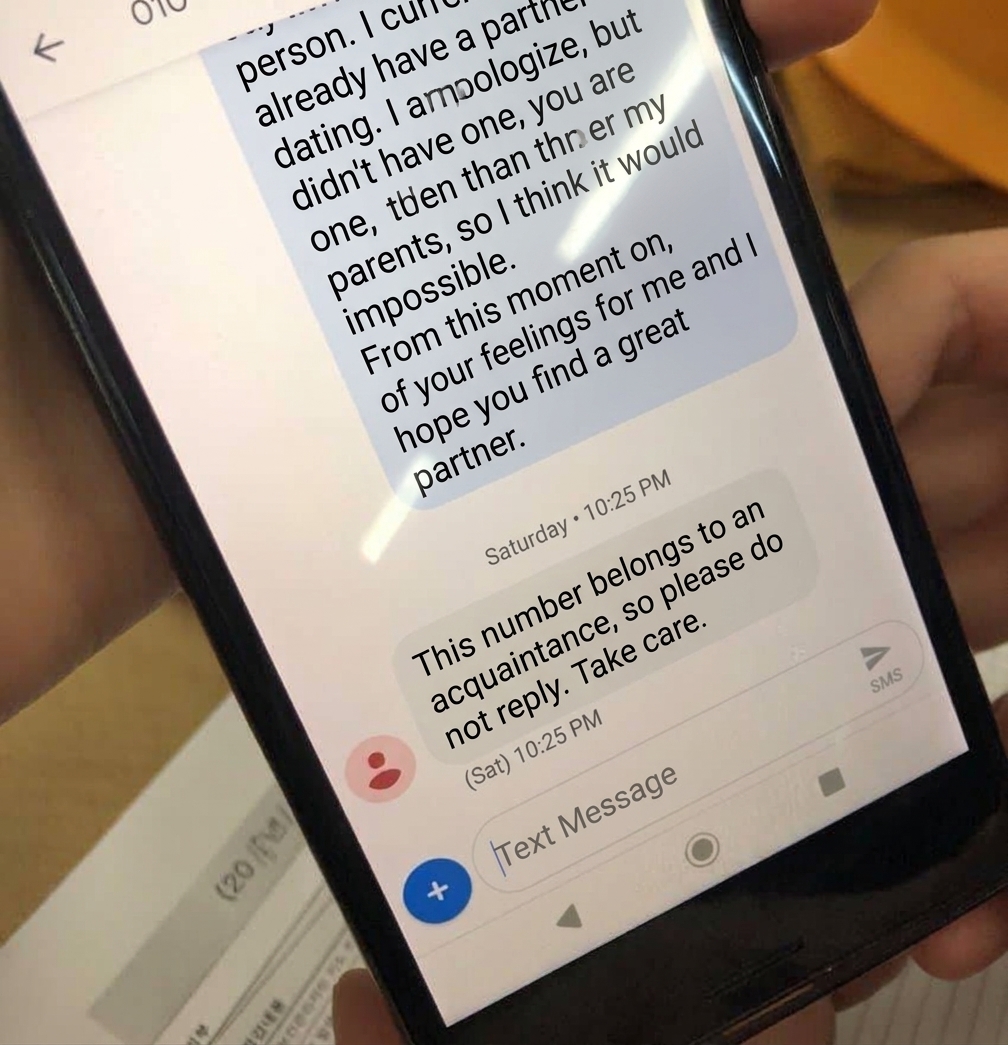 A smartphone screen showing a polite rejection message mentioning the worker is older than the sender's parents, followed by the man's reply stating he will live looking only at her even if it never works out.