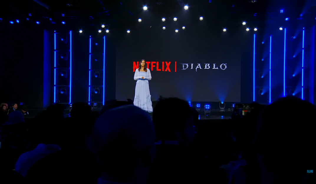 A presentation stage screen displaying the Netflix and Diablo logos side by side.