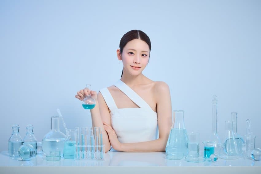 A female model posing behind laboratory equipment