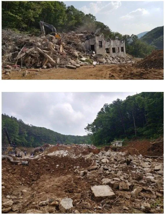 Photo of the ruins of the Gonjiam Psychiatric Hospital being demolished by an excavator.