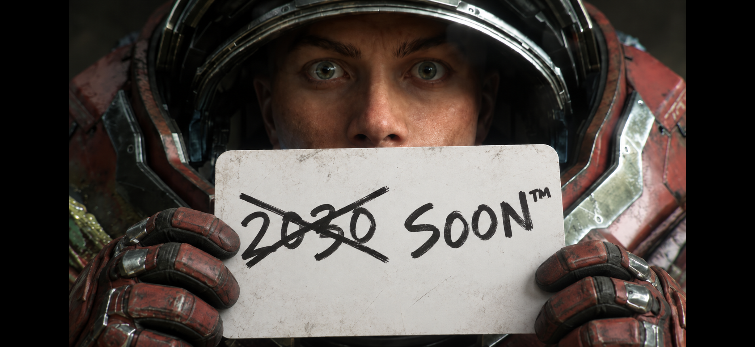 宇宙服を着たテラン海兵が、「2030」に線が引かれ、「SOON™」と書かれた看板を持っている様子。