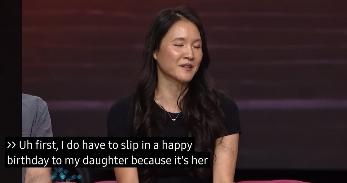 A female developer speaking on the BlizzCon stage with English subtitles.