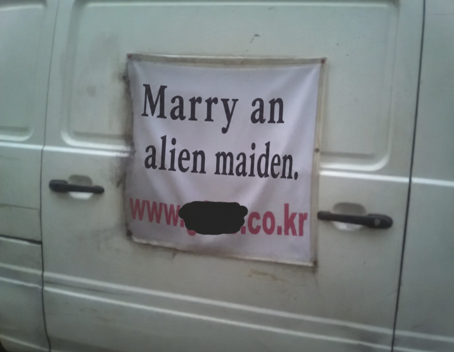 A banner hanging on the back of a vehicle with a ridiculous typo that says 'Marry an alien virgin'.