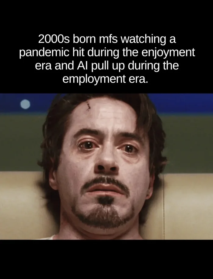 A meme featuring a close-up of Robert Downey Jr. looking pale and traumatized, with text reading: '2000s born mfs watching a pandemic hit during the enjoyment era and AI pull up during the employment era.'