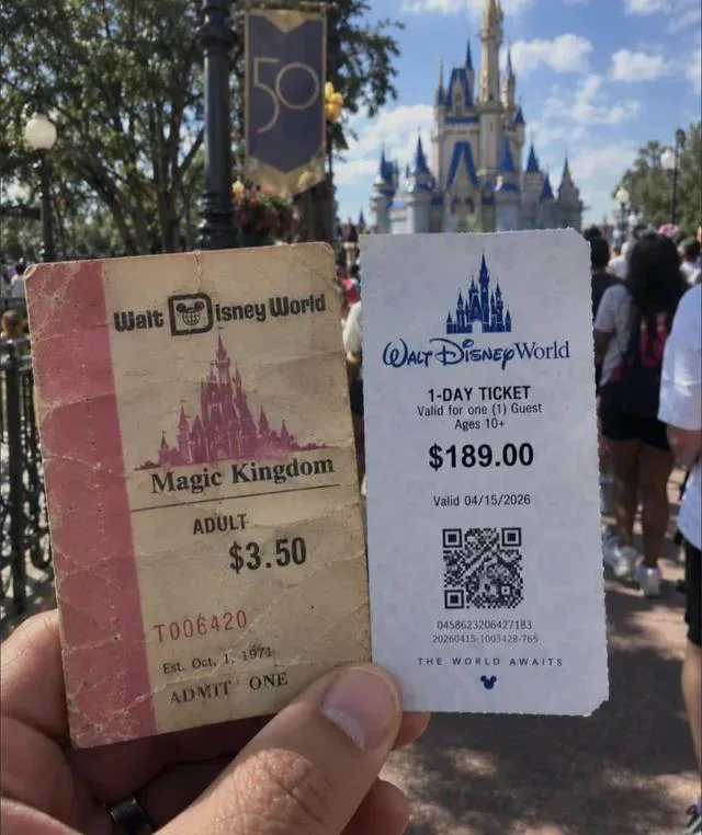 A hand holding an old 1971 Walt Disney World adult ticket priced at $3.50 next to a modern ticket priced at $189.00, with Cinderella Castle in the background.
