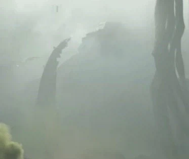 Magnified view of the area circled in red, revealing the outlines of an angular artificial structure in the fog.