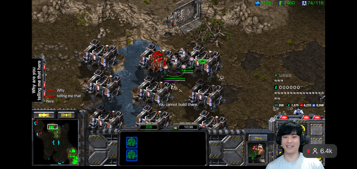 A game screen showing the area around the Zerg main base cliff densely surrounded by multiple Barracks, with the opponent complaining in the chat.
