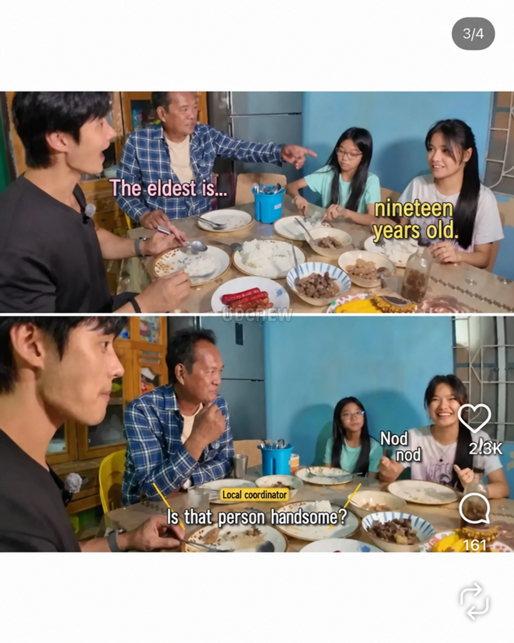 A girl nodding while looking at a man, with family sitting around the table talking.