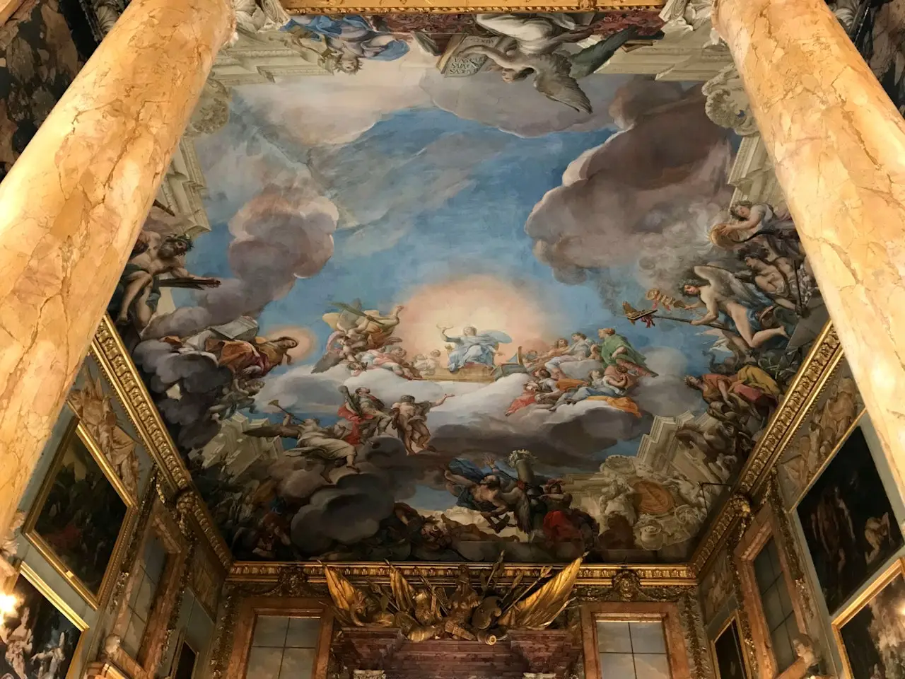 Ceiling fresco at Palazzo Colonna in Rome depicting clouds, angels, and saints among marble columns
