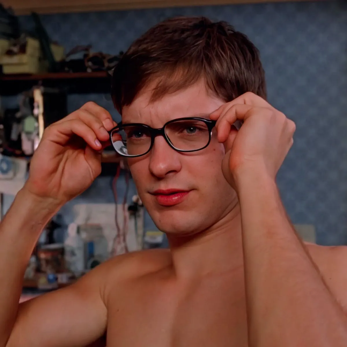 Peter Parker putting his glasses back on.