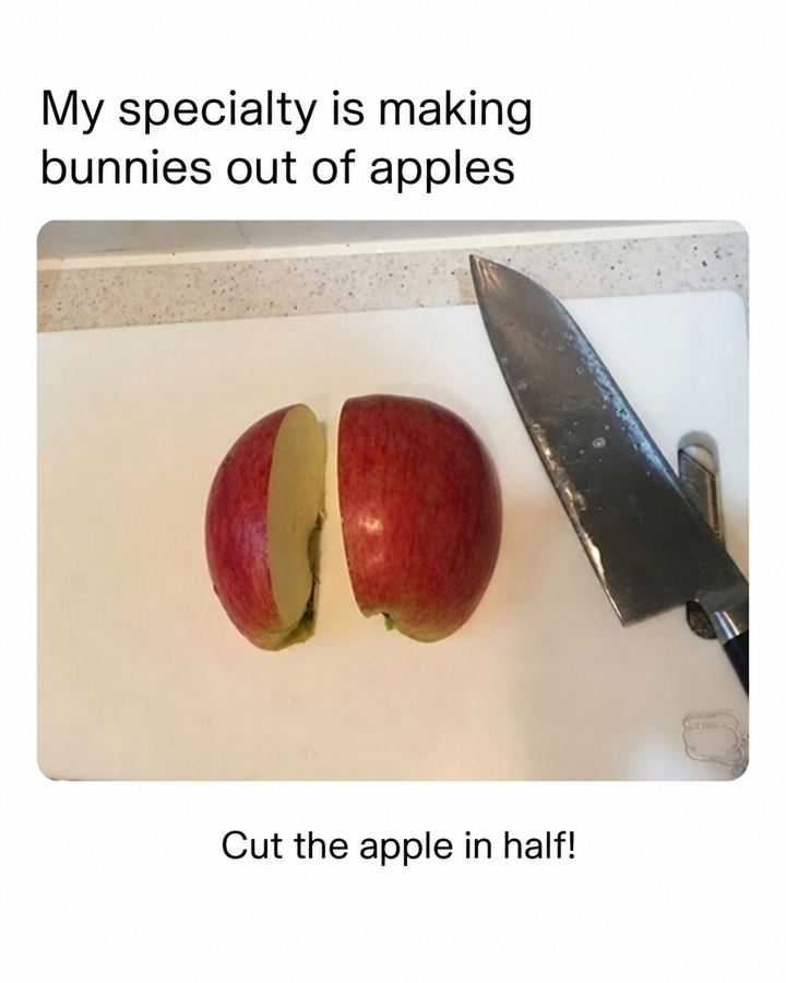 A photo of a halved apple and a kitchen knife on a cutting board, with the text 'My specialty is making bunnies out of apples' at the top and 'Cut the apple in half!' at the bottom.