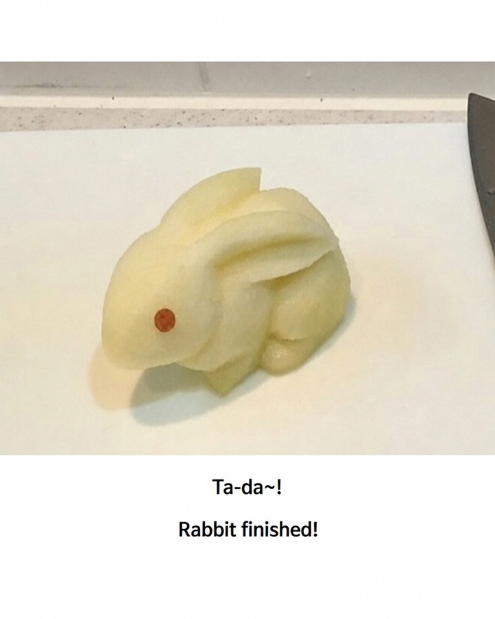 A photo of the peeled apple now suddenly transformed into a sophisticated, three-dimensional rabbit sculpture, with the text 'Ta-da~! Rabbit finished!' at the bottom.