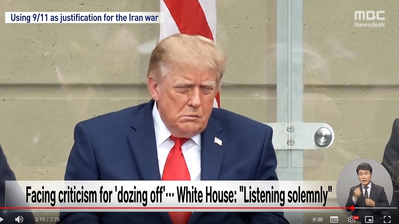 A television news screen capture showing Donald Trump looking down with his eyes half-closed during a 9/11 memorial event.