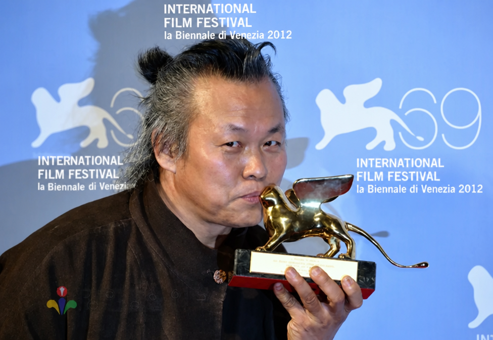 Director Kim Ki-duk kissing the Golden Lion trophy at the Venice Film Festival