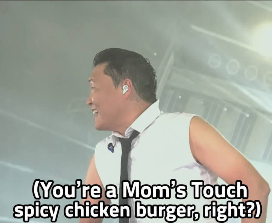 Psy smiling on stage with subtitles
