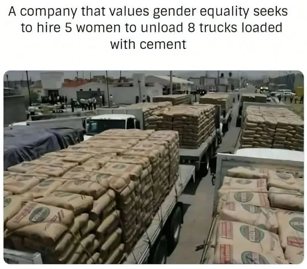 A line of flatbed trucks piled high with heavy bags of cement parked outside a warehouse.