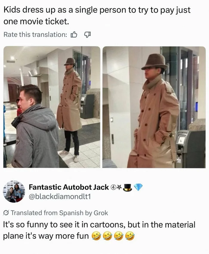 A person wearing an oversized beige trench coat and fedora standing in a cinema lobby, visibly appearing to be two people stacked on top of each other.
