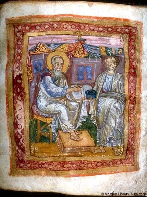 An illustration from an ancient biblical manuscript showing a haloed saint seated on a chair writing with a quill, with a figure standing beside him handing him a vessel.