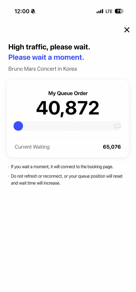 Smartphone screen showing a queue position of 40,872 and 65,076 people currently waiting for the Bruno Mars concert ticket booking.