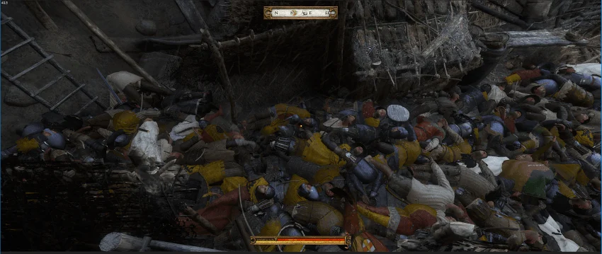 A tightly packed heap of fallen soldiers' bodies tangled together beneath a wooden structure