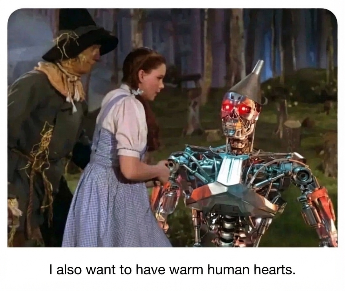 A composite image of a red-eyed Terminator wearing a tin funnel hat standing before Dorothy and the Scarecrow from the movie The Wizard of Oz. A subtitle below reads, 'I also want to have warm human hearts.'