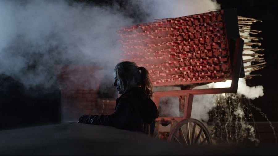 A scene from The Walking Dead with a Hwacha placed next to a roof wall.