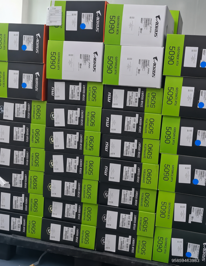 A tall stack of MSI and Aorus branded GeForce RTX 5090 graphics card boxes.