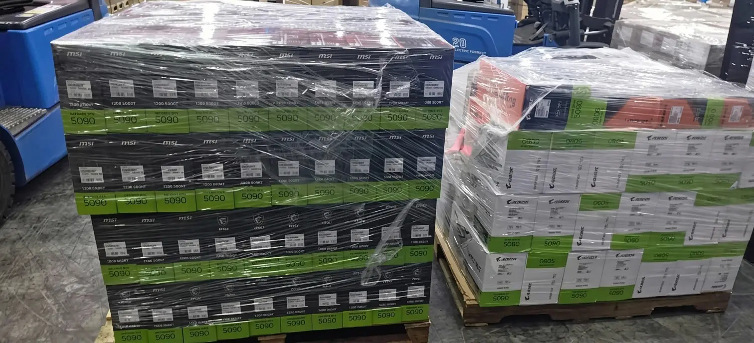 A large quantity of MSI and Aorus GeForce RTX 5090 graphics card boxes stacked on a logistics warehouse pallet, tightly wrapped in plastic film.