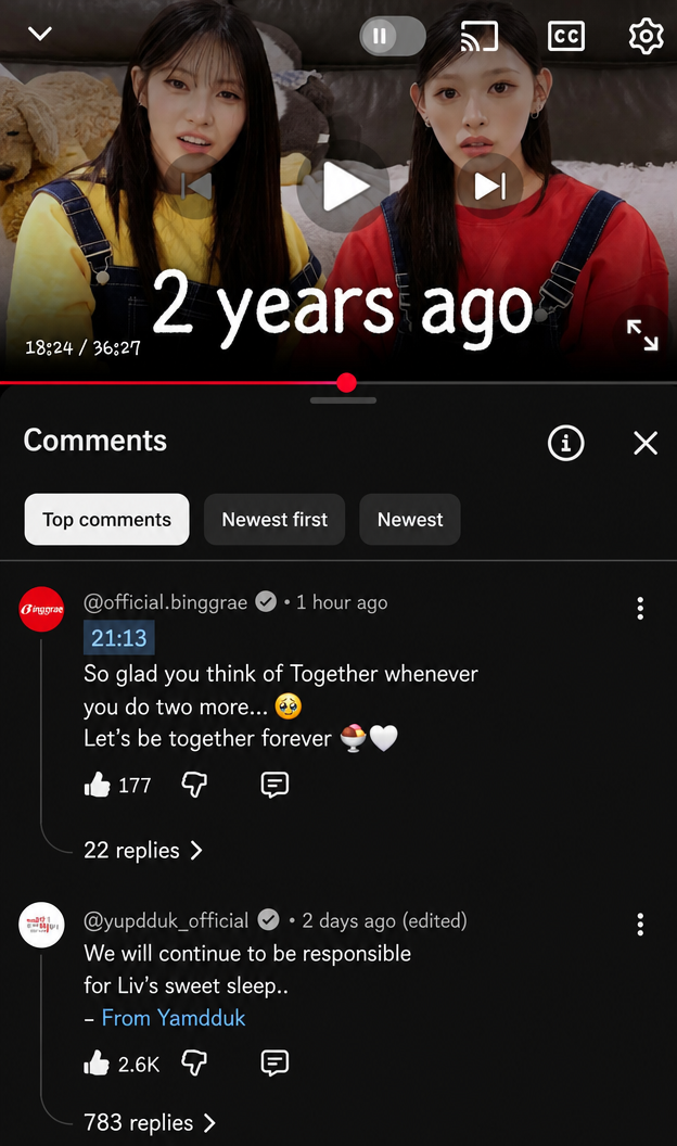 A screen capture of YouTube comments where the official Binggrae account wrote 'So glad you think of Together whenever you do two more' and the official Yupdduk account wrote 'We will continue to be responsible for Liv's sweet sleep'.