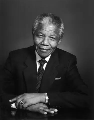 A black and white portrait of Nelson Mandela.